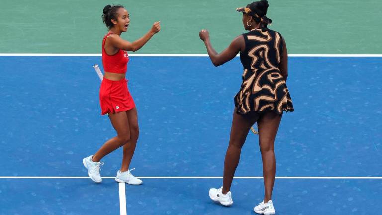 Leylah Fernandez of Canada (L) and partner Venus Williams of the United States fist bump during their Women’s Doubles Third Round match against Shuai Zhang of China and Ekaterina Alexandrova on Day Nine of the 2025 US Open at USTA Billie Jean King National Tennis Center on September 1, 2025 in the Flushing neighborhood of the Queens borough of New York City. Matthew Stockman/Getty Images/AFP