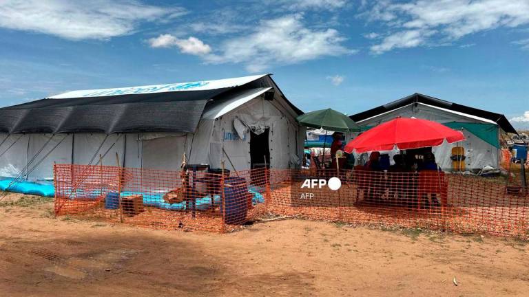 People sit outside the cholera isolation centre in at the refugee camps of western Sudan, in Tawila city in Darfur, on August 14, 2025. At least 40 people have died in Sudan’s Darfur region in the country’s worst cholera outbreak in years, Doctors Without Borders (MSF) said on August 14. (Photo by AFP)