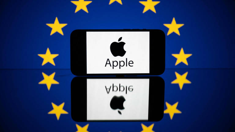 This picture taken on April 27, 2023 in Toulouse, southwestern France, shows a screen displaying the Apple logo and the European flag. - AFP
