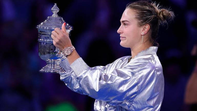 Aryna Sabalenka poses with her trophy after defeating Amanda Anisimova of the United States during their Women’s Singles Final match. - Clive Brunskill/Getty Images/AFP