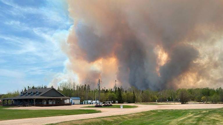 Smoke rises from a wildfire as seen off Granite Park Road in Lac Du Bonnet, Manitoba, Canada May 13, 2025. REUTERSpix