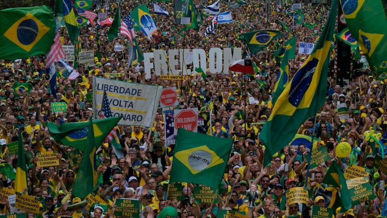 Supporters of Brazil’s former president (2019-2022) Jair Bolsonaro, on trial for his alleged role in an attempted coup, hold the word “Freedom” in a demonstration during Independence Day, in Sao Paulo, Brazil on September 7, 2025. - NELSON ALMEIDA / AFP