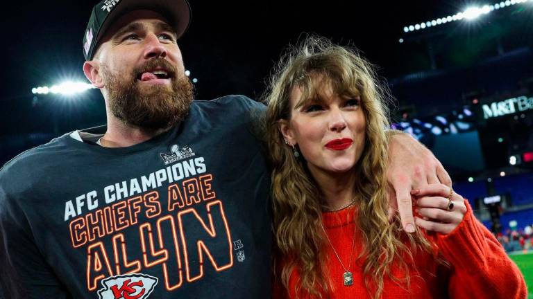 Travis Kelce #87 of the Kansas City Chiefs (L) celebrates with Taylor Swift after defeating the Baltimore Ravens in the AFC Championship Game at M&amp;T Bank Stadium on January 28, 2024 in Baltimore, Maryland. GETTY IMAGES NORTH AMERICA / AFP