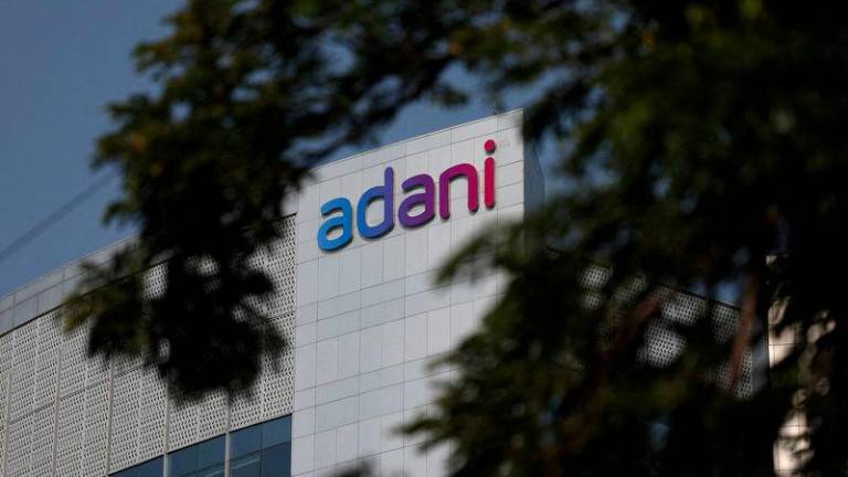 The logo of the Adani Group is seen on the facade of its Corporate House on the outskirts of Ahmedabad, India, November 21, 2024. - REUTERSPIX