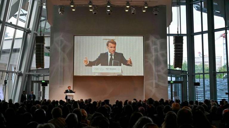 French President Emmanuel Macron (Rear L) delivers a speech during the opening ceremony of the 142nd Session of the International Olympic Committee (IOC), four days ahead of the opening ceremony of the Paris 2024 Olympics, at the Louis-Vuitton foundation in Paris - AFPpix