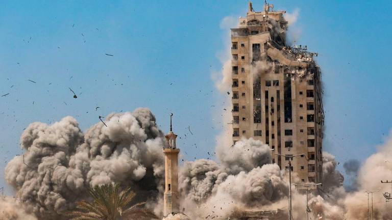 Smoke billows during Israeli strikes on the Mushtaha Tower in Gaza City on September 5, 2025, amid the war between Israel and the Hamas militant movement. (Photo by Omar AL-QATTAA / AFP)