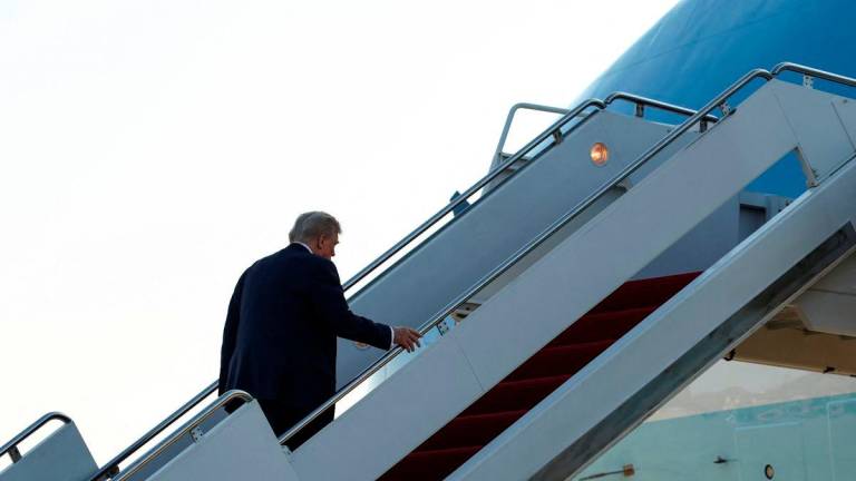 U.S. President Donald Trump boards Air Force One as he departs for Alaska to meet with Russian President Vladimir Putin to negotiate for an end to the war in Ukraine, from Joint Base Andrews in Maryland, U.S., August 15, 2025. REUTERS/Kevin Lamarque