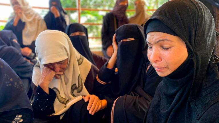 Women react during the funeral for victims killed by Israeli bombardment on the Mawasi area of Khan Yunis, at Nasser Medical Complex in Khan Yunis in the southern Gaza Strip on July 28, 2025. (Photo by AFP)