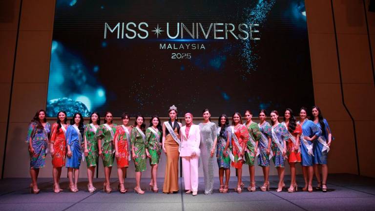 Miss Universe Malaysia 2024 Sandra Lim (in gold), Livonia and Chong with the top 16 finalists at the press conference in Bangsar.