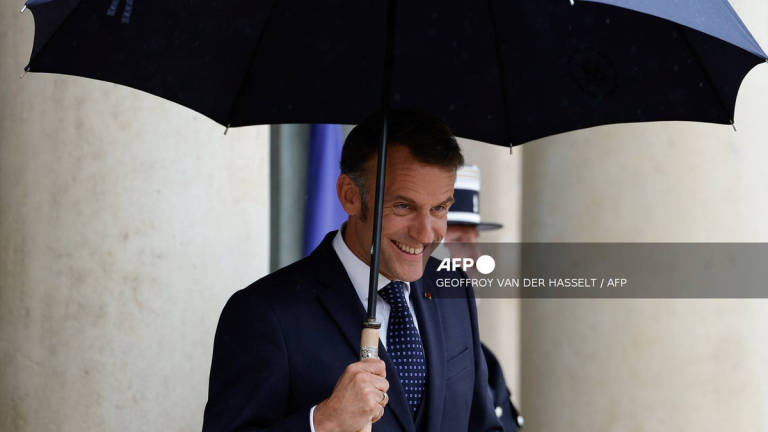 France's President Emmanuel Macron waits for Lebanon's Prime Minister ahead of their working lunch at the presidential Elysee Palace in Paris, on July 24, 2025. - AFP