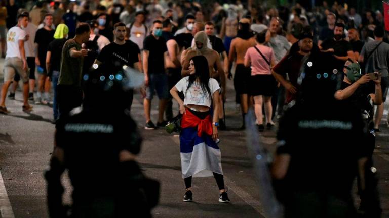 Protesters confront Serbian riot police as tens of thousands gather in central Belgrade to deliver an “ultimatum” to the populist government, demanding early elections after months of student-led strikes across the country, on June 28, 2025. (Photo by OLIVER BUNIC / AFP)