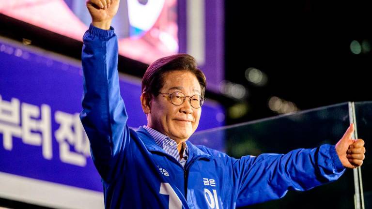 Lee Jae-myung, the presidential candidate for South Korea’s Democratic Party, gestures onstage during his final election campaign event ahead of the upcoming June 3 presidential election in Seoul on June 2, 2025. (Photo by Anthony WALLACE / AFP)