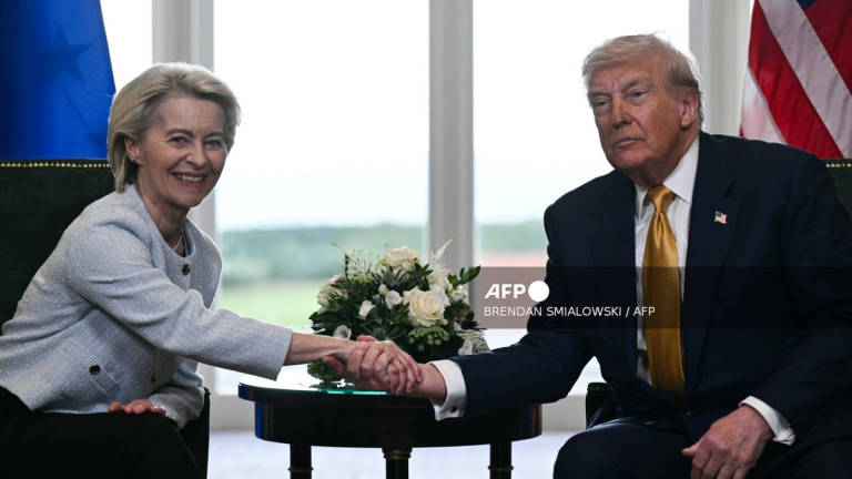 US President Donald Trump (R) shakes hands with European Commission President Ursula von der Leyen (L) after agreeing on a trade deal between the two economies following their meeting, in Turnberry south west Scotland on July 27, 2025, on the third day of his visit to the country, since his second tenure as President began. - AFP