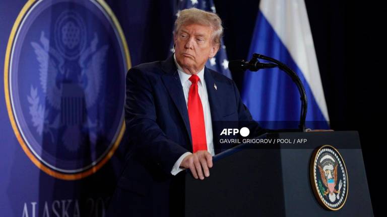 In this pool photograph distributed by the Russian state agency Sputnik, US President Donald Trump listens to Russian President Vladimir Putin during a joint press conference after participating in a US-Russia summit on Ukraine at Joint Base Elmendorf-Richardson in Anchorage, Alaska, on August 15, 2025. - Gavriil GRIGOROV / POOL / AFP