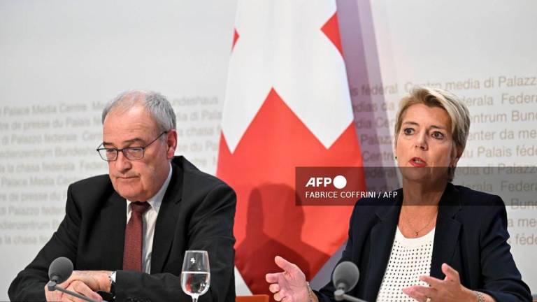 Swiss President Karin Keller-Sutter (R) speaks next to Swiss Economy Minister Guy Parmelin during a press conference following an extraordinary meeting after Swiss government failed to convince the US government not to impose 39 percent tariffs on Swiss goods, in Bern on August 7, 2025. - AFP