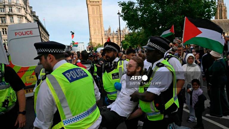 A protester is carried away by police officers at a Lift The Ban demonstration in support of the proscribed group Palestine Action, calling for the recently imposed ban to be lifted, in Parliament Square, central London, on September 6, 2025. - AFP