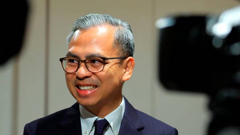 Communications Minister Datuk Fahmi Fadzil speaks to the media after concluding a historic two-day official visit to Timor-Leste with Prime Minister Datuk Seri Anwar Ibrahim and the Malaysian delegation today. - BERNAMA