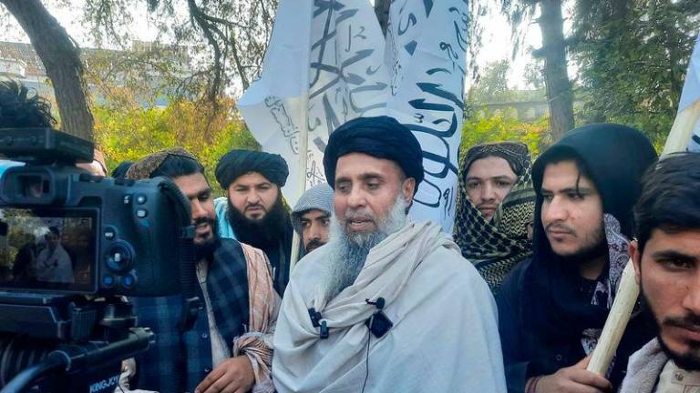 Afghan fighter Khan Mohammad (C) who was imprisoned in America, speaks to the media as he arrived in Jalalabad after he was released in exchange for American citizens - AFPpix