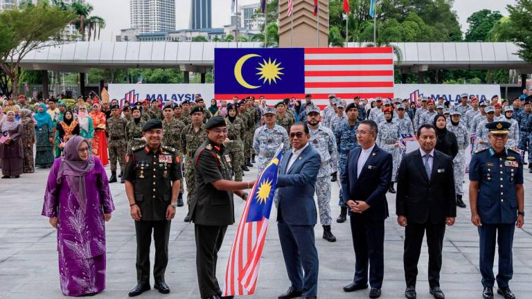 The Minister of Defence, Datuk Seri Mohamed Khaled Nordin (fourth from the right), presented the Jalur Gemilang to the Chief of Defence Forces, General Tan Sri Mohd Nizam Jaffar (third from the left) at the Launching Ceremony of the National Day and Malaysia Day (HKHM) 2025 Celebration at the Defence Ministry Plaza today. - BERNAMA