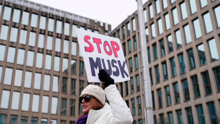 People gather to protest outside the headquarters of the Office of Personnel Management (OPM) after the Elon Musk-led Department of Government Efficiency (DOGE) was charged with oversight of OPM, in Washington, U.S. February 2, 2025. REUTERSpix