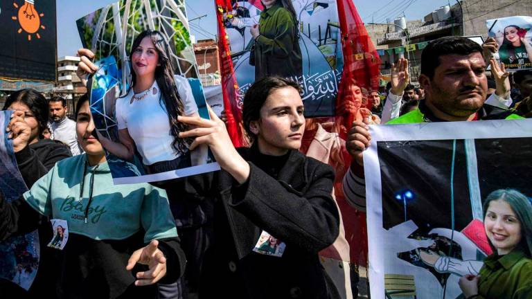 People gather for a mass demonstration in Syria’s northeastern city of Qamishli on March 11, 2025 protesting against a recent wave of sectarian violence targeting Syria’s Alawite minority in the west of the country along the Mediterranean sea coast. (Photo by Delil SOULEIMAN / AFP)