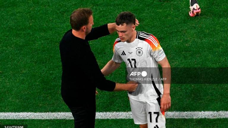 Germany's head coach Julian Nagelsmann (L) congratulates Germany's midfielder #17 Florian Wirtz as he leaves the pitch to be substituted during the UEFA Euro 2024 Group A football match between Germany and Scotland at the Munich Football Arena in Munich on June 14, 2024. - AFP