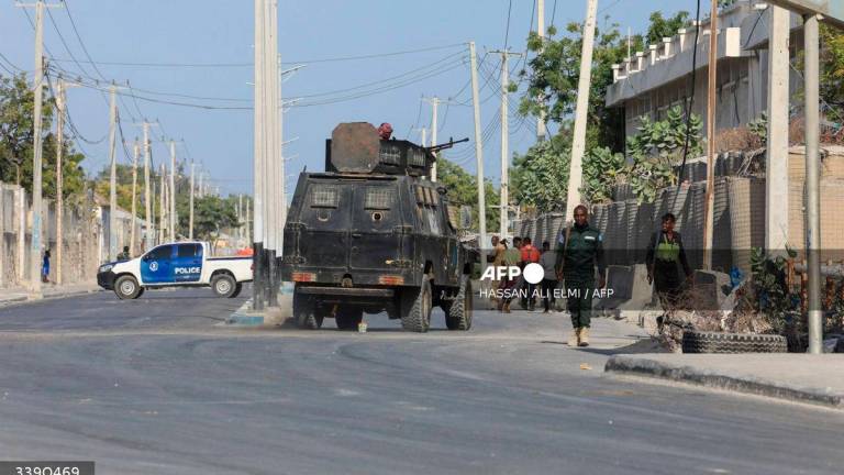 Security forces patrol outside a building which was attacked by suspected Al Shabaab militants in the Somalia’s capital Mogadishu, on February 21, 2023. (Photo by Hassan Ali ELMI / AFP)