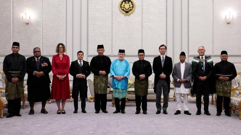 His Majesty, Sultan Ibrahim, King of Malaysia, poses for a photo after receiving the credentials of six new foreign envoys to Malaysia and presenting the instruments of appointment to the Malaysian Ambassador to Thailand at Istana Negara today. - BERNAMAPIX