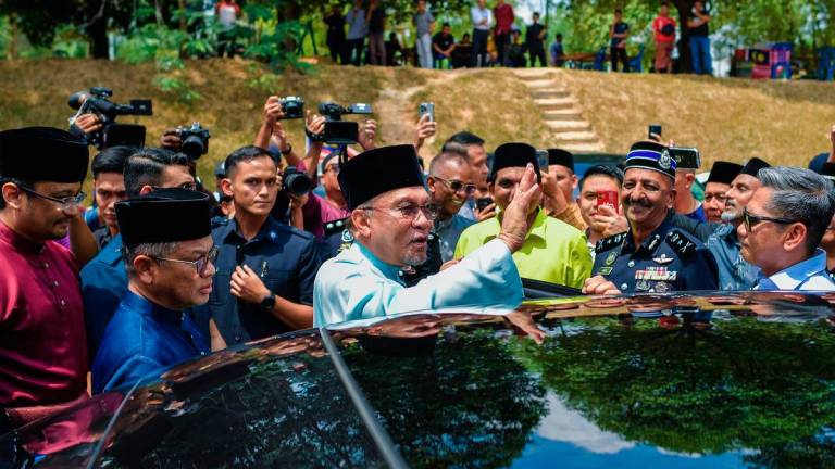 Prime Minister Datuk Seri Anwar Ibrahim greets congregants after performing Friday prayers at Surau Al-Muttaqin 5R6 here today. - BERNAMA