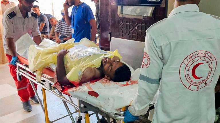 A Palestinian man who was wounded while attempting to get aid at the Rafah corridor receives treatment at the the Nasser Hospital in Khan Yunis on July 7, 2025. (Photo by AFP)