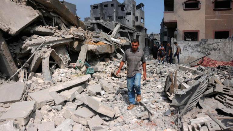 A Palestinian man walk next to the rubble of a residential house that was hit in overnight Israeli strikes in Jabalia in the northern Gaza Strip, on June 30, 2025, as the was between Israel and the Hamas Islamist militant movement continues. (Photo by Bashar TALEB / AFP)