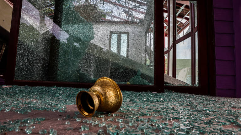 Broken glass lies on the ground inside a damaged building inside Phanom Dong Rak Hospital, following being hit by Cambodia's artillery, after Thailand scrambled an F-16 fighter jet to bomb targets in Cambodia on Thursday after artillery volleys from both sides killed civilians, in Surin, Thailand, July 25, 2025. - REUTERS
