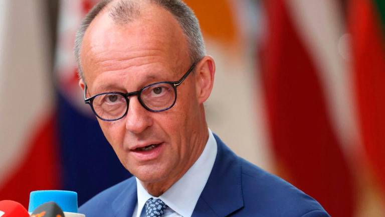 Germany’s Chancellor Friedrich Merz speaks to the press as he arrives to attend the European Council in Brussels on June 26, 2025. (Photo by ALAIN JOCARD / AFP)