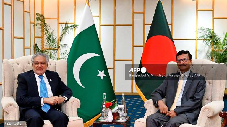 Foreign Affairs Advisor of Bangladesh’s interim government Mohammad Touhid Hossain (R) posing alongside Pakistan’s Foreign Minister Ishaq Dar during a bilateral meeting in Dhaka. - (Photo by Bangladesh’s Ministry of Foreign Affairs / AFP)