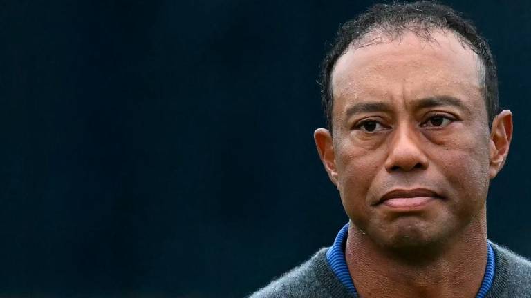 (FILES) US golfer Tiger Woods reacts on the 18th green after his first round 79 on the opening day of the 152nd British Open Golf Championship at Royal Troon on the south west coast of Scotland on July 18, 2024 - Photo by Paul ELLIS / AFP