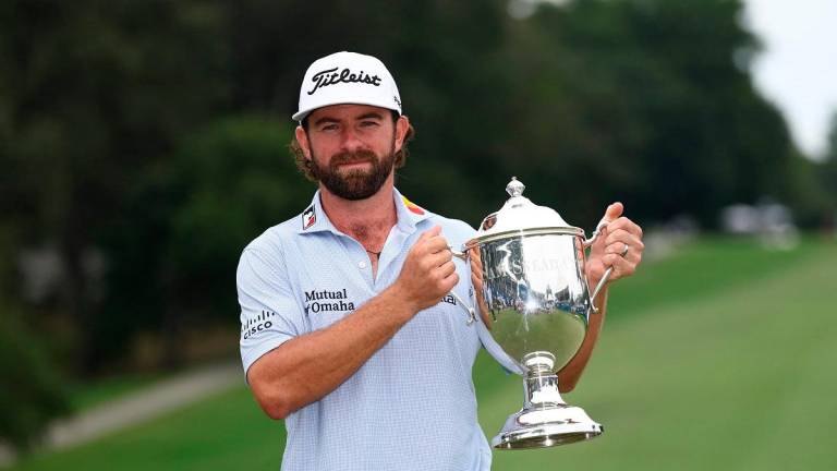 Cameron Young of the United States poses with the Wyndham Championship trophy on the 18th green after the final round of the Wyndham Championship 2025 at Sedgefield Country Club on August 03, 2025 in Greensboro, North Carolina. - Jared C. Tilton/Getty Images/AFP