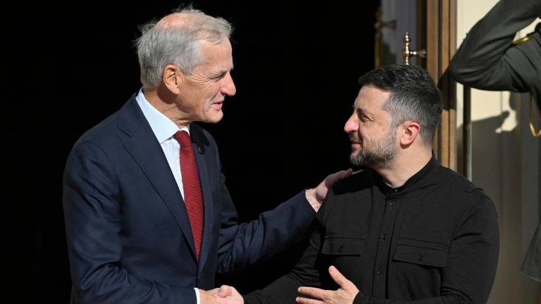 Ukrainian President Volodymyr Zelensky (R) shakes hands with Prime Minister of Norway Jonas Gahr Store as they arrive for their talks at Mariyinsky Palace in Kyiv on August 25, 2025, amid the Russian invasion in Ukraine. - Genya SAVILOV / AFP
