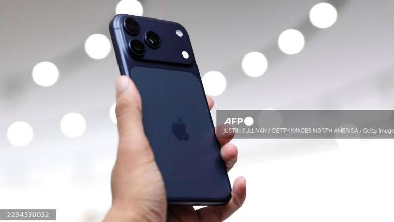 A next generation iPhone 17 is held during an Apple special event at Apple headquarters on September 9, 2025 in Cupertino, California. - Getty Images via AFP
