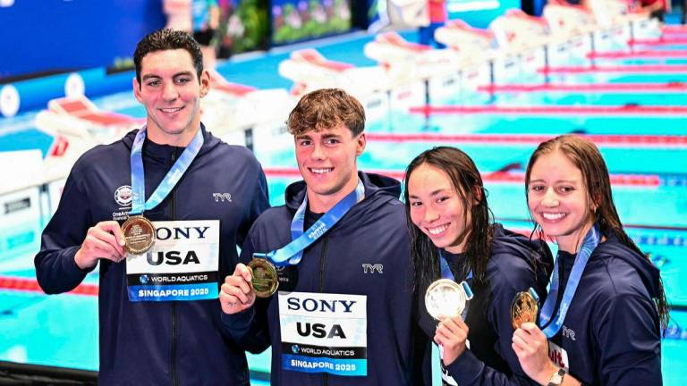 (From L) Gold medallists US' swimmer Jack Alexy, US' swimmer Patrick Sammon, US' swimmer Kate Douglass and US' swimmer Torri Huske celebrate on the podium of the mixed 4x100m freestyle relay swimming event during the 2025 World Aquatics Championships in Singapore on August 2, 2025. - AFPPIX