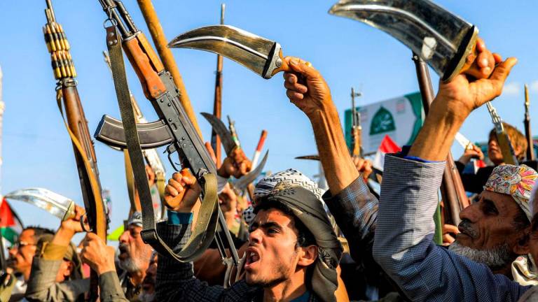 Supporters of Yemen’s Huthis display weapons and chant slogans as they gather for a rally condemning Israel and in support of Palestinians, near the Saleh Grand Mosque in the Huthi-held capital Sanaa on October 3, 2025. (Photo by Mohammed HUWAIS / AFP)