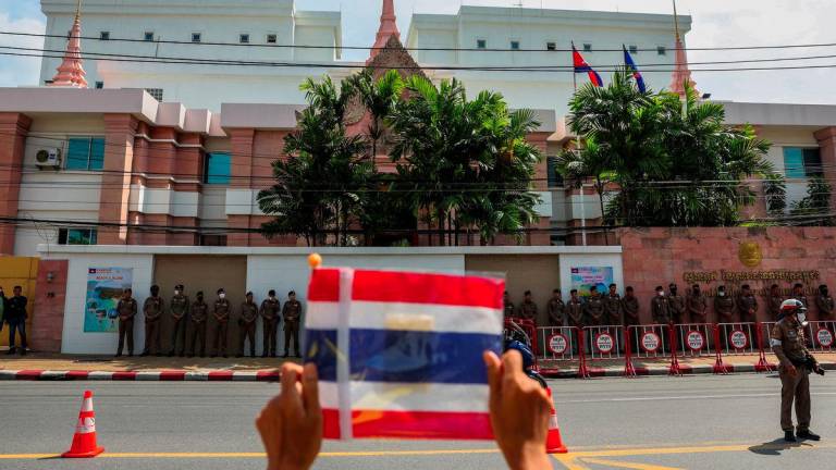 A royalist activist holds a Thai flag as he protests in front of the Royal Embassy of Cambodia, following a recent clash at the Thailand-Cambodia border on May 28, 2025, in Bangkok, Thailand, June 6, 2025. - REUTERSPIX