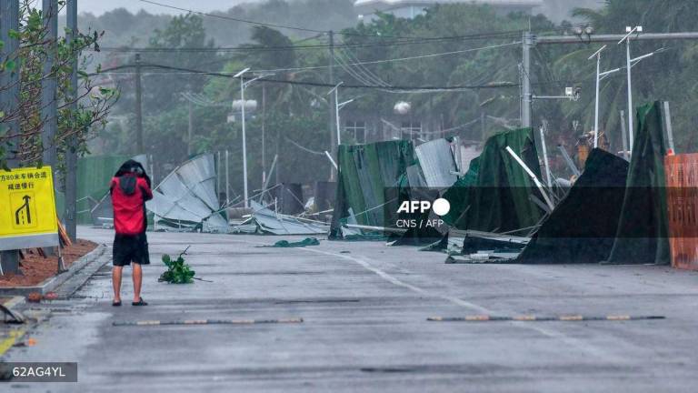 A damaged wall is seen as Typhoon Wutip approaches in Sanya in China's southern Hainan province on June 13, 2025. - CNS / CNS / AFP
