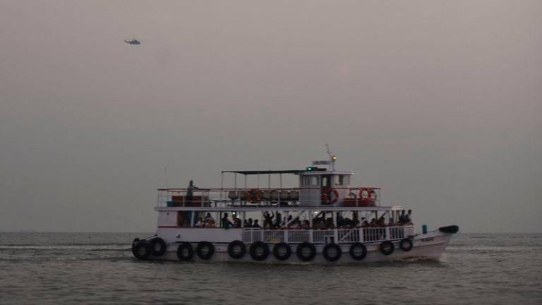 A military helicopter flies over a ferry during a rescue operation after a passenger boat capsized off the coast of India’s financial capital Mumbai - REUTERS/Stringer