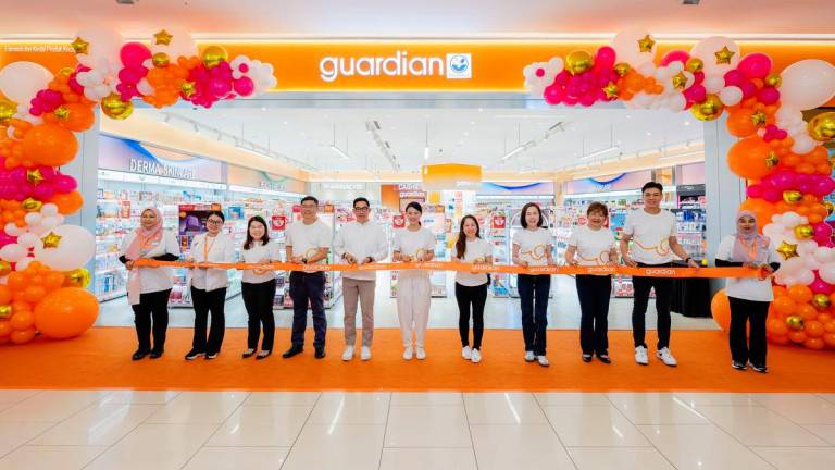 Priscilla Wu (sixth from left) flanked by Peter Chan (GM Queensbay Mall, Gurney Plaza and East Coast Mall) to her right and Anna Ng (Marketing Director, guardian Malaysia) to her left at the ribbon cutting cere