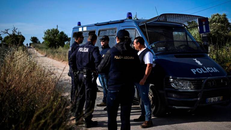 Portuguese Criminal Investigation Police (PJ) investigators stand in a road for a new search operations amid the investigation into the disappearance of Madeleine (or Maddie) McCann in Lagos, in the Algarve region, on June 3, 2025. (Photo by Patricia DE MELO MOREIRA / AFP)