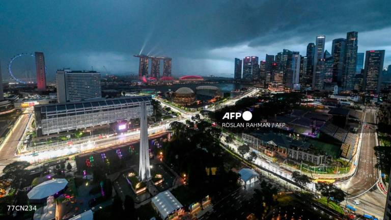 This photo shows the road circuit illuminated for the the upcoming Formula One Singapore Grand Prix at the Marina Bay Street Circuit in Singapore on October 1, 2025. - AFPPIX