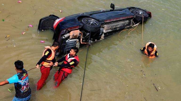 Jabatan Bomba dan Penyelamat Malaysia (JBPM) giat membawa naik kenderaan yang tenggelam di dasar sungai dengan kedalaman empat meter di Sungai Tanjung Agas semalam. - BERNAMA