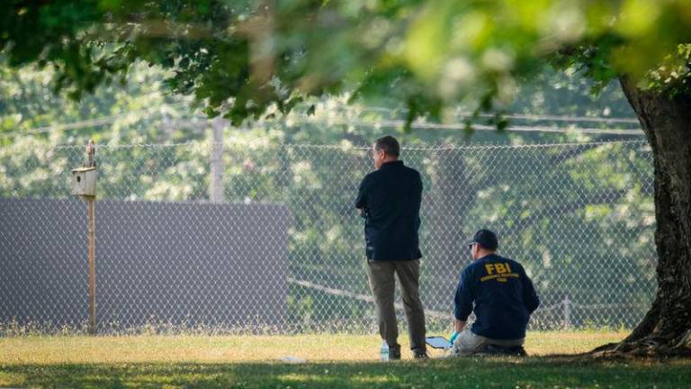 Members of the FBI Evidence Response Team, work near the building where a gunman was shot dead by law enforcement - REUTERSpix