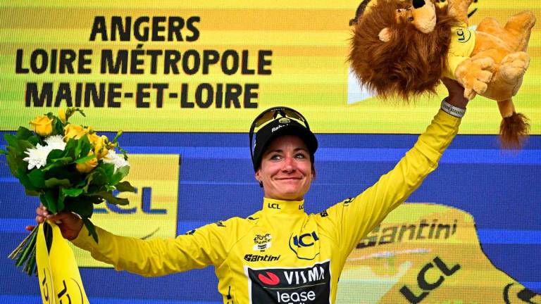 Team Visma | Lease a Bike's Dutch rider Marianne Vos celebrates on the podium with the overall leader's yellow jersey after the 3rd stage (out of 9) of the fourth edition of the Women's Tour de France cycling race, 163.5 km from La Gacilly to Angers, in Angers, western France on July 28, 2025. - AFPPIX