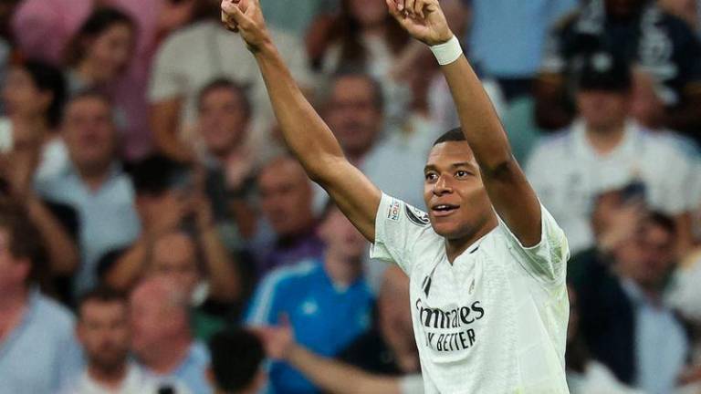 Real Madrid's French forward #09 Kylian Mbappe celebrates after scoring his team's first goal during the UEFA Champions League 1st round day 1 football match between Real Madrid CF and Stuttgart VFB at the Santiago Bernabeu stadium in Madrid on September 17, 2024. - AFPPIX